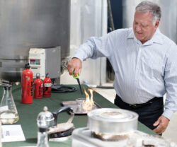 David Blume demonstrates how clean fuel burns at Blume Distillation Calabasas Road in Watsonville. — photo by Juan Martinez file